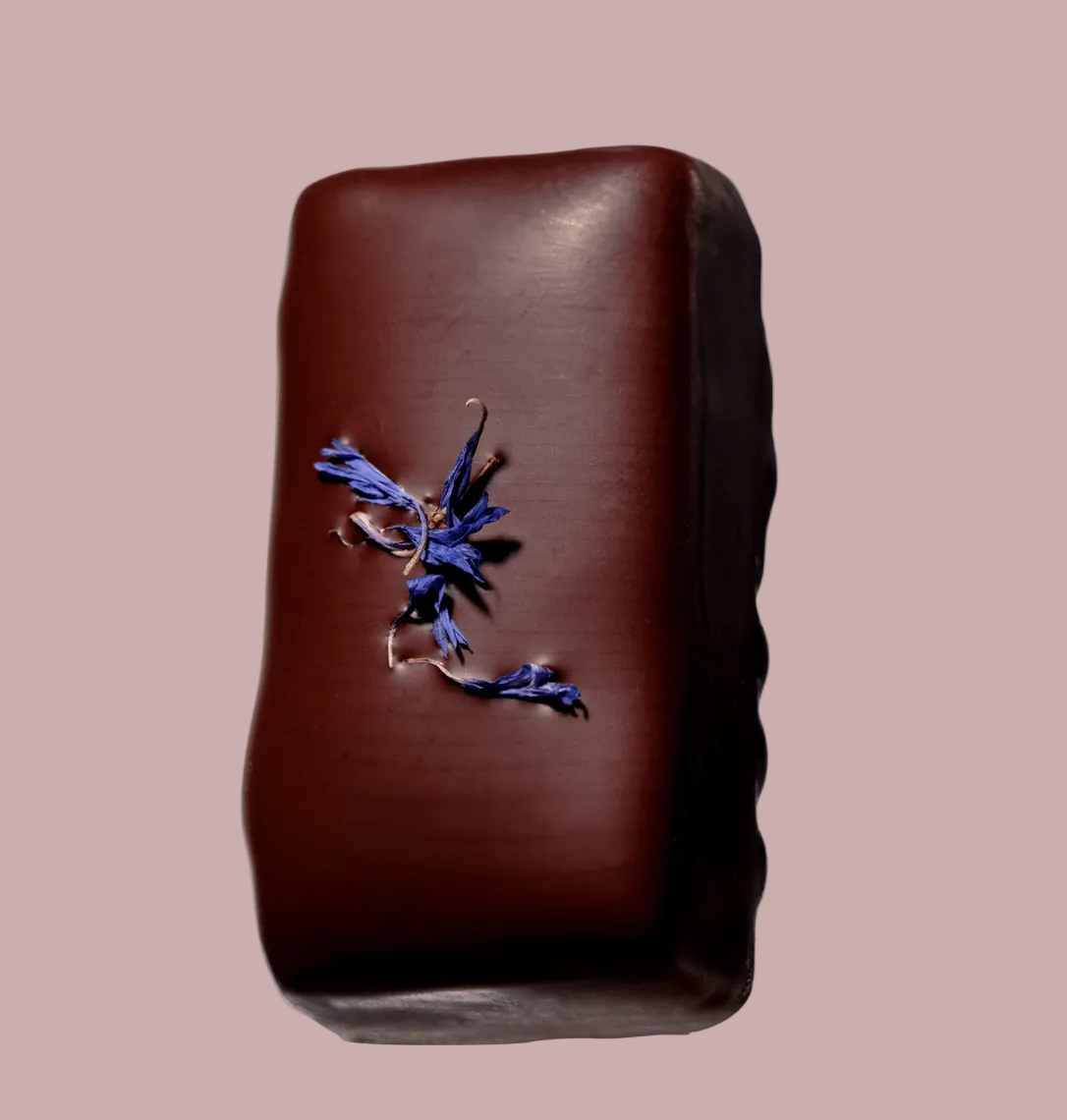 Chocolate bar with a floral decoration on a light blue background