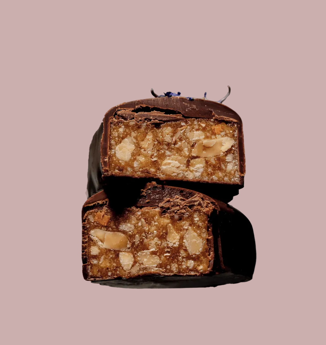 Two chocolate bars cut open, revealing a nougat filling against a light blue background